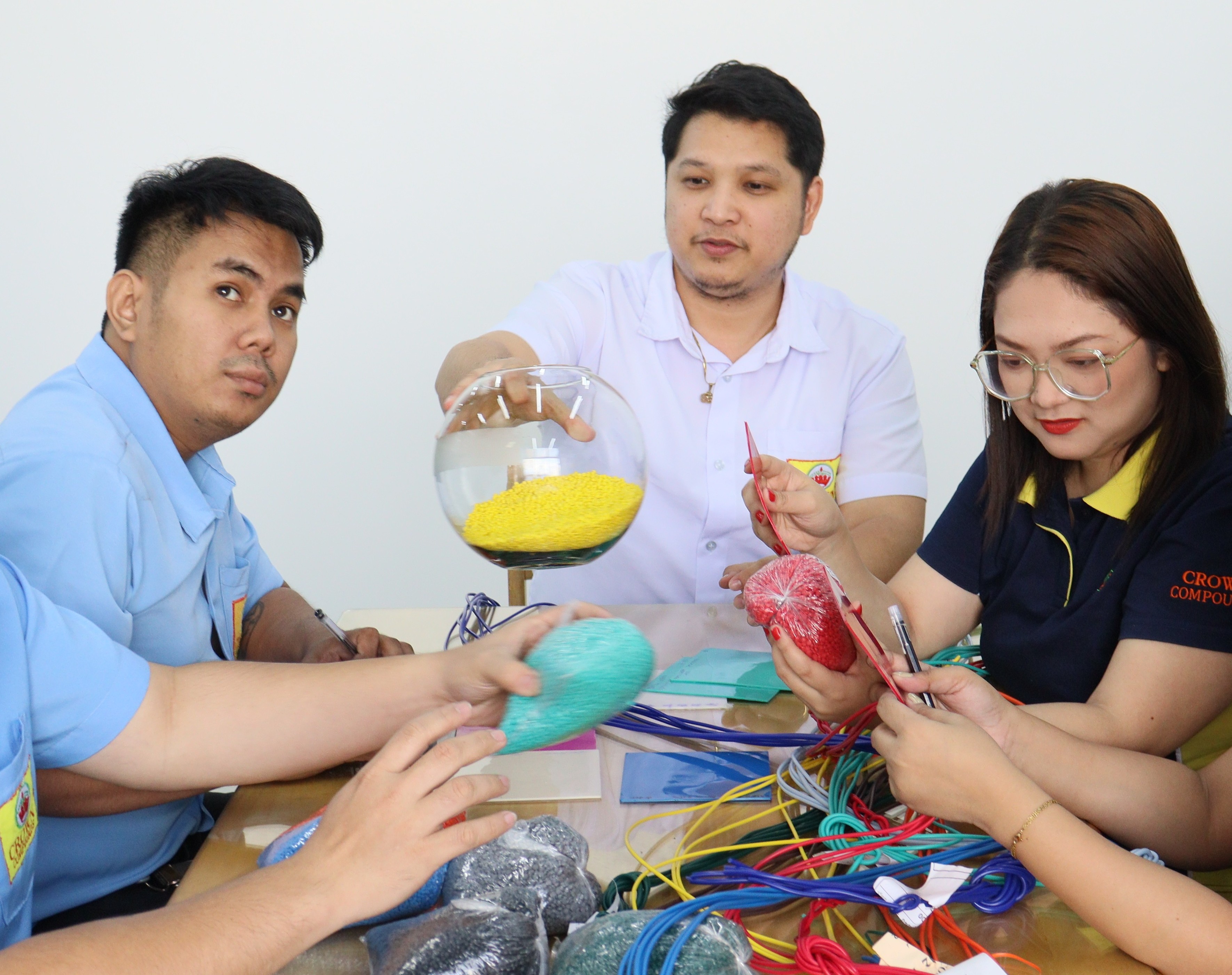 CROWN team inspecting PVC compound samples